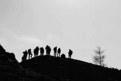 Silhouette of two people against sky