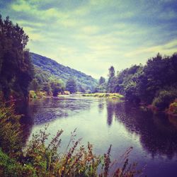 Scenic view of lake against cloudy sky