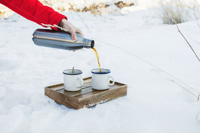 Person holding ice cream in snow