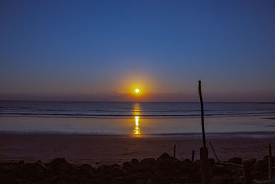 Scenic view of sea against clear sky during sunset