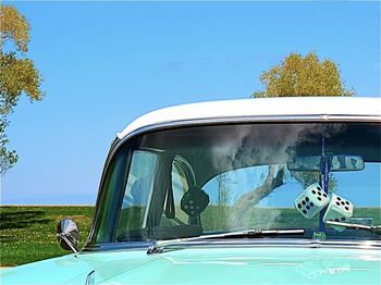 Cars on road against clear blue sky