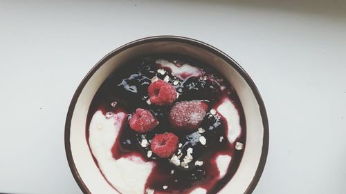 High angle view of raspberries in bowl on table