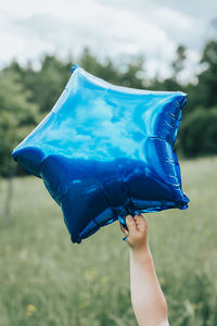 Midsection of woman holding umbrella