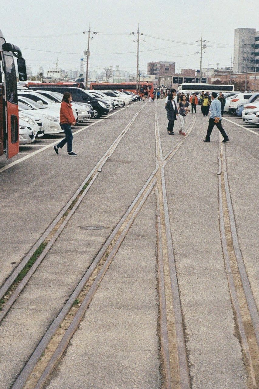 PEOPLE WALKING ON RAILROAD TRACK