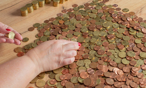 Cropped hand of woman holding coins