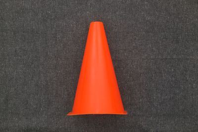 High angle view of orange flag on table against blue background