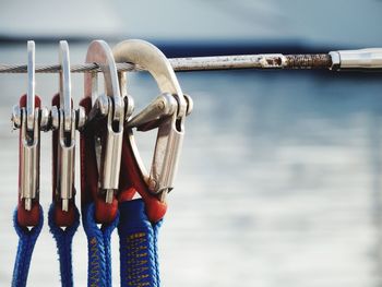 Close-up of safety hooks hanging on cable