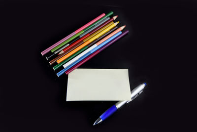 Close-up of colored pencils against black background