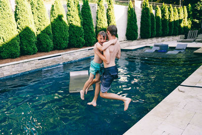 Full length of shirtless man in swimming pool