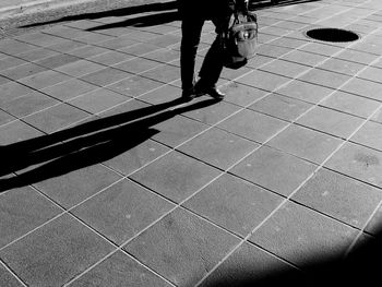 Low section of people walking on sidewalk
