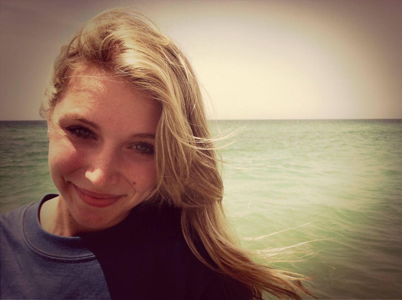 sea, young adult, headshot, lifestyles, young women, water, leisure activity, person, long hair, horizon over water, beach, clear sky, portrait, head and shoulders, looking at camera, copy space, brown hair