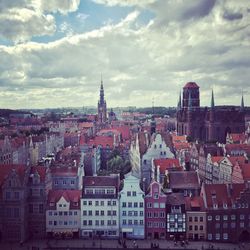 Cityscape against cloudy sky