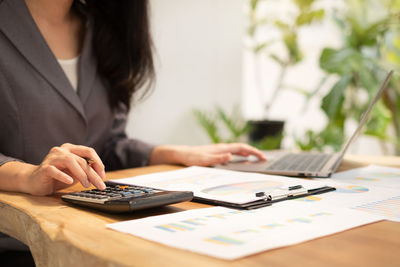 Midsection of businesswoman working at office