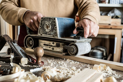 Midsection of man working in work shop