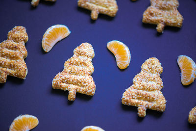 High angle view of christmas cookies with orange slices on table