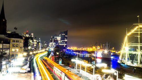 High angle view of light trails on street against sky at night