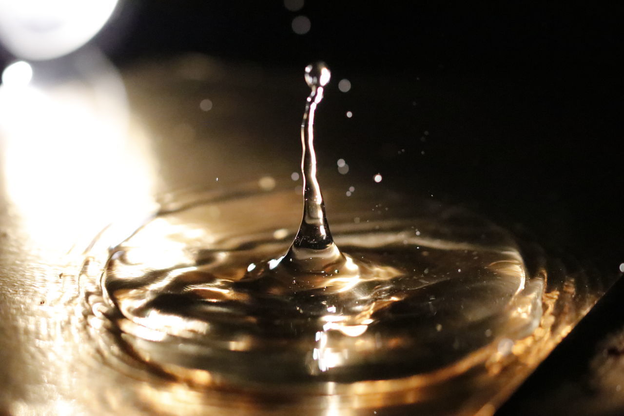 CLOSE-UP OF SPLASHING WATER IN GLASS