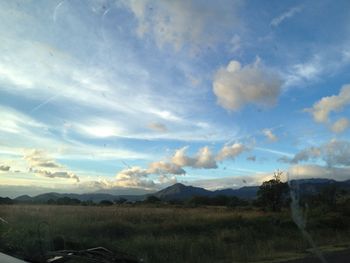 Scenic view of landscape against cloudy sky