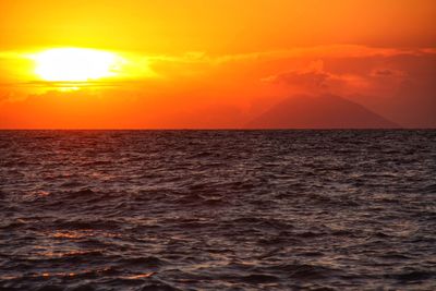 Scenic view of sea against romantic sky at sunset