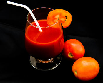 Close-up of orange juice against black background