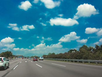 Cars on road against sky