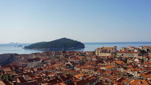 Townscape by sea against clear sky