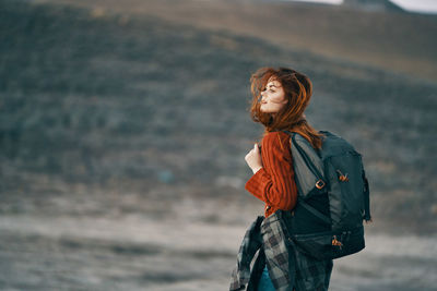 Man looking away while standing on land