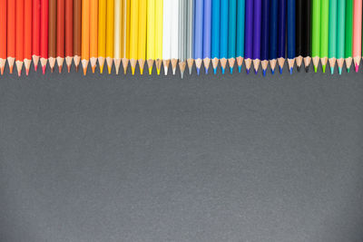 Multi colored pencils in row