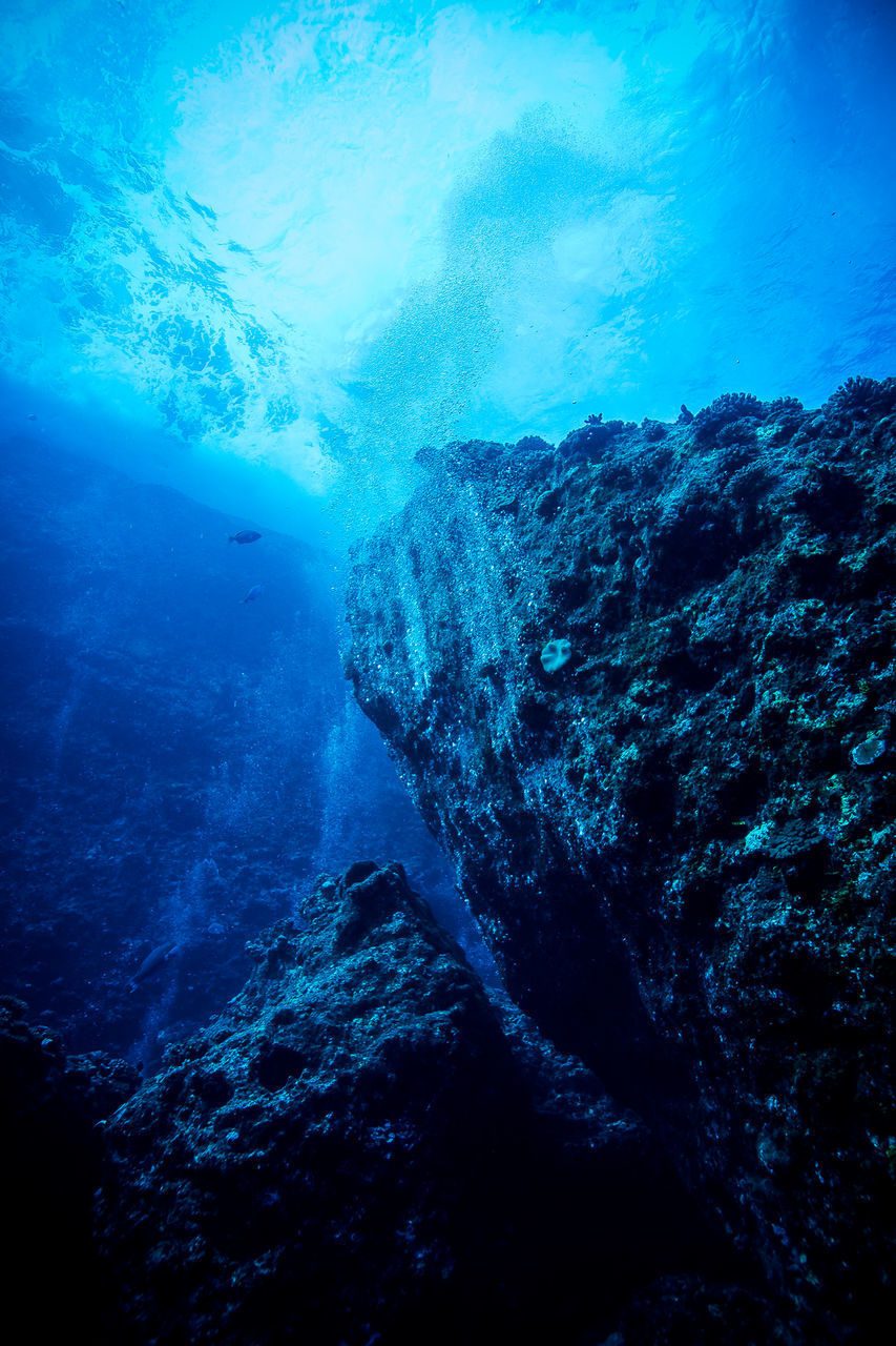 Low angle view of rocks in sea