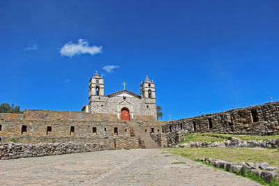 Low angle view of old building against blue sky