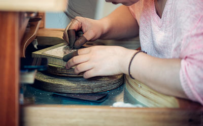 Midsection of man working in workshop