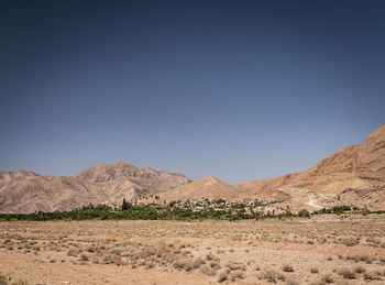 Scenic view of desert against clear blue sky