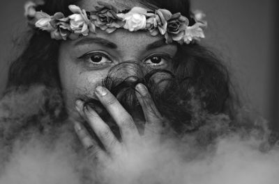 Close-up portrait of woman wearing flowers