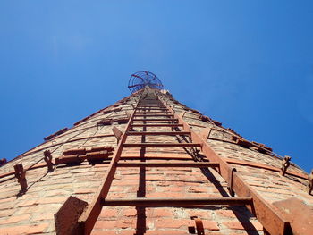 Low angle view of old building against blue sky