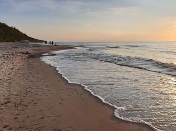 Scenic view of beach against sky during sunset