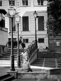 Woman standing by building in city