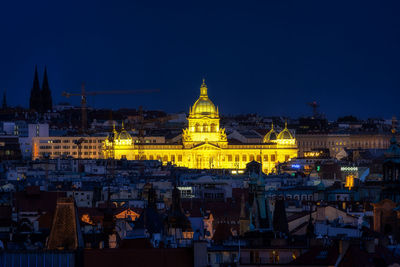 Illuminated buildings against sky at night