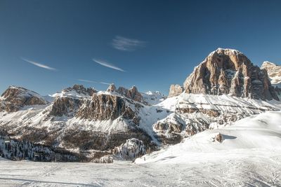 Scenic view of snow covered field and mountains against sky