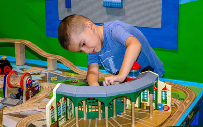 Young boy playing with a train table at a train museum