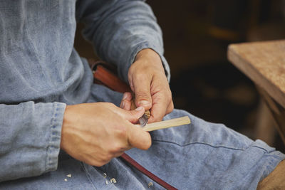 Midsection of man working in workshop