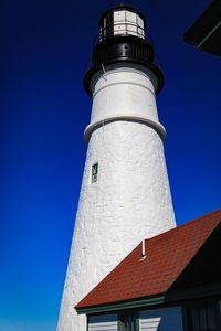 Low angle view of lighthouse against clear blue sky