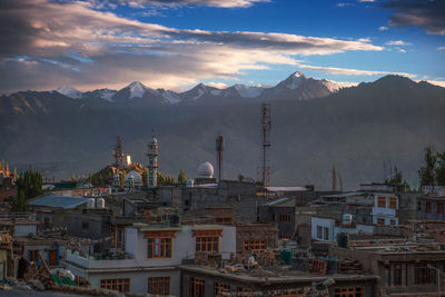 View of cityscape against cloudy sky