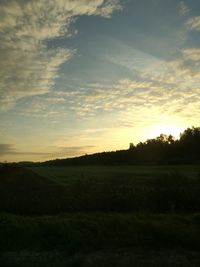 Scenic view of field against sky during sunset