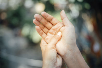 Close-up of hand holding hands