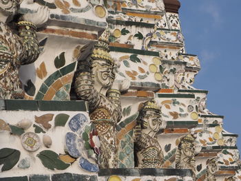 Low angle view of statue against temple