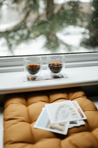 Coffee cup on table against window