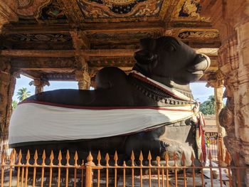 Low angle view of statue against temple building