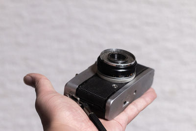 Close-up of hand holding film camera