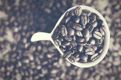 Directly above shot of roasted coffee beans in cup