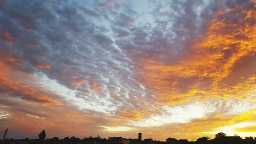 Low angle view of dramatic sky during sunset